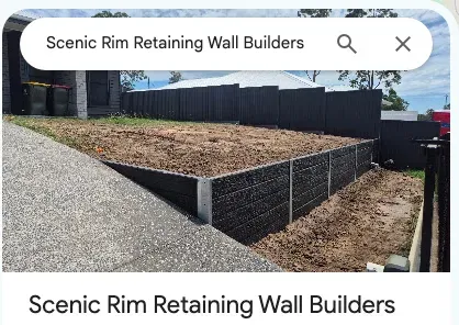 The Scenic Rim Retaining Wall Builders Google Maps listing: the business name over a photo of a new charcoal concrete sleeper wall beside a driveway.