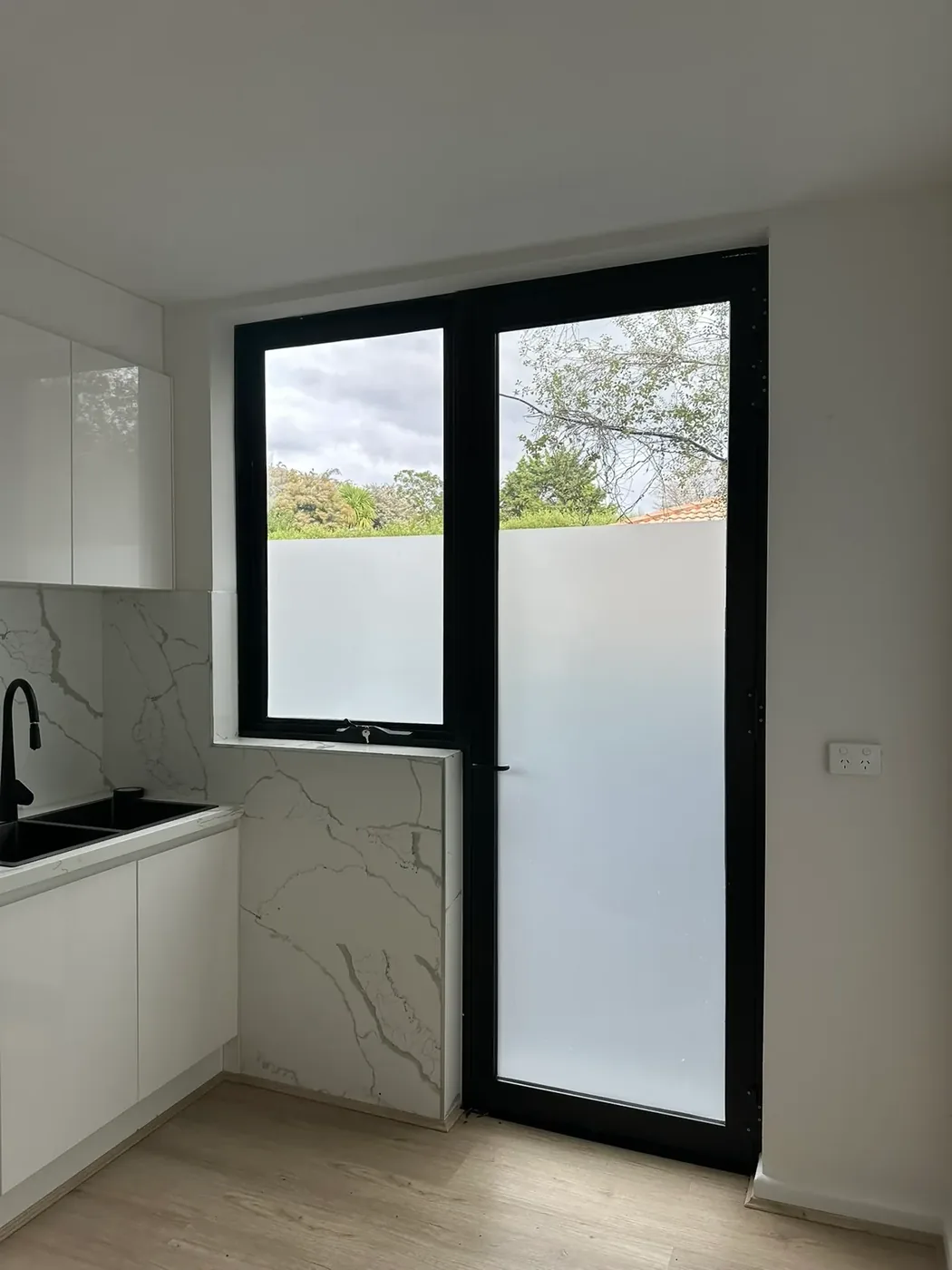 Frosted privacy film on a kitchen door in a renovated Kew East home